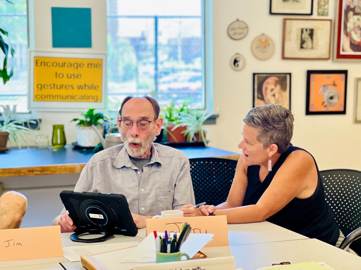 people talking at a computer