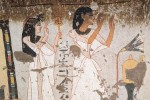 Egyptian tomb plaster art showing two figures, one male and another female, with their arms raised