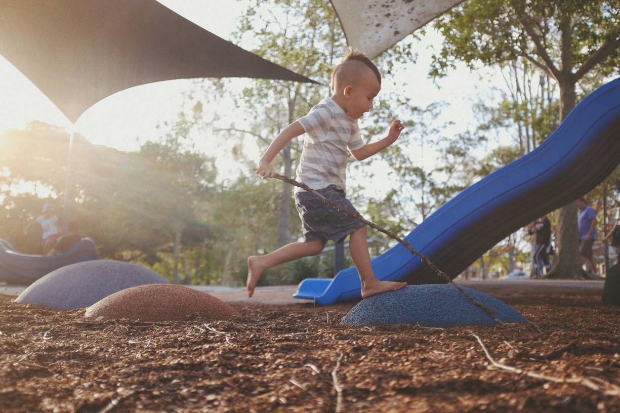 A young boy plays outside