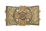 An ornately decorated gold and silver clasp features interlacing and scrolling knotwork designs.