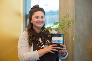 Student holding plant