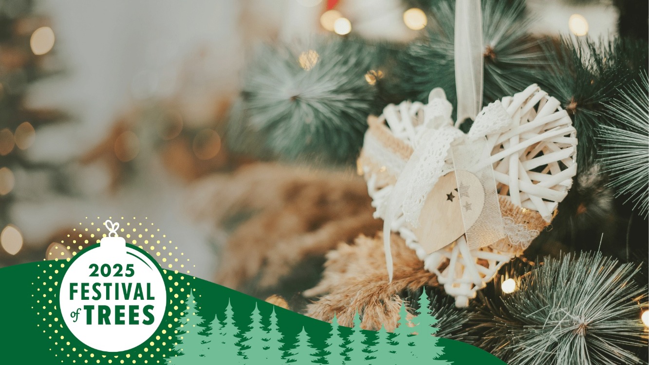 handmade heart shaped ornament hanging from Christmas tree branch