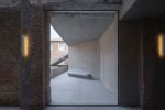 View of concrete wall seen through a wide doorway.