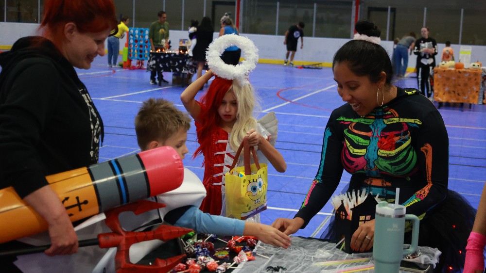 Trick-or-treaters at the Family Fieldhouse get candy, prizes, and play games