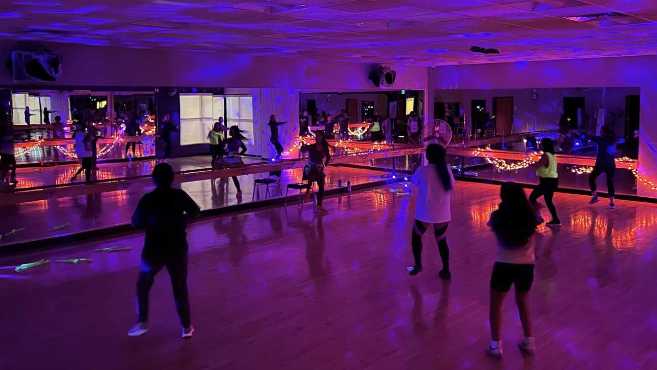 Zombie Zumba® takes place at the Family FunPlex with black lighting.