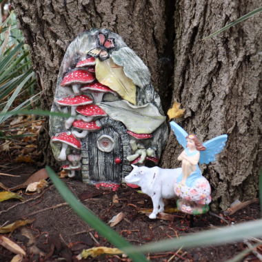 Fairy door with a fairy and a tiny cow
