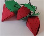 Three paper strawberries made out of red and green construction paper with black marker and string Three paper strawberries made out of red and green construction paper with black marker and string
