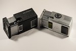 Two Soviet era subminiature cameras. On the left is a Kiev-30 and to the right, a Kiev Vega 2.