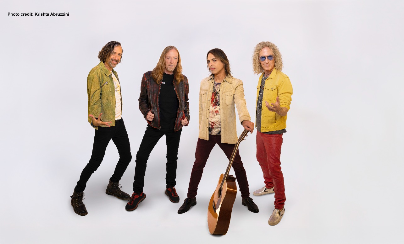 Four members of band foreigner stand against a white background