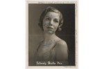 Photograph studio portrait of a woman with short hair and a spaghetti strap dress, with blue ink and graphite writing on the photograph.