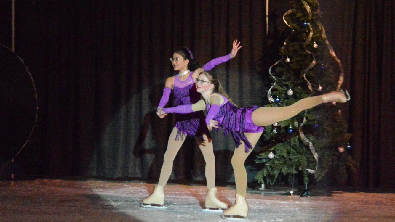 Two girls ice skating during the winter ice show at the Greeley Ice Haus