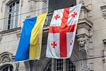 Georgian and Ukrainian flag hung side by side, in a Georgian street.