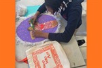 A girl working on her self-portrait in class