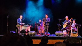 Band playing on a stage.