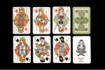 Eight playing cards are laid out on a black background: A pair of kings, queens, and jacks; one card with an intricate design in green and red; and another card, a joker, featuring a seated, white-bearded man.