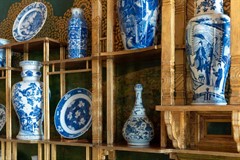 Gilded shelves filled with blue and white porcelain