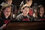 Members of the Harvard University Choir sing during a candlelight servce in Appleton Chapel.