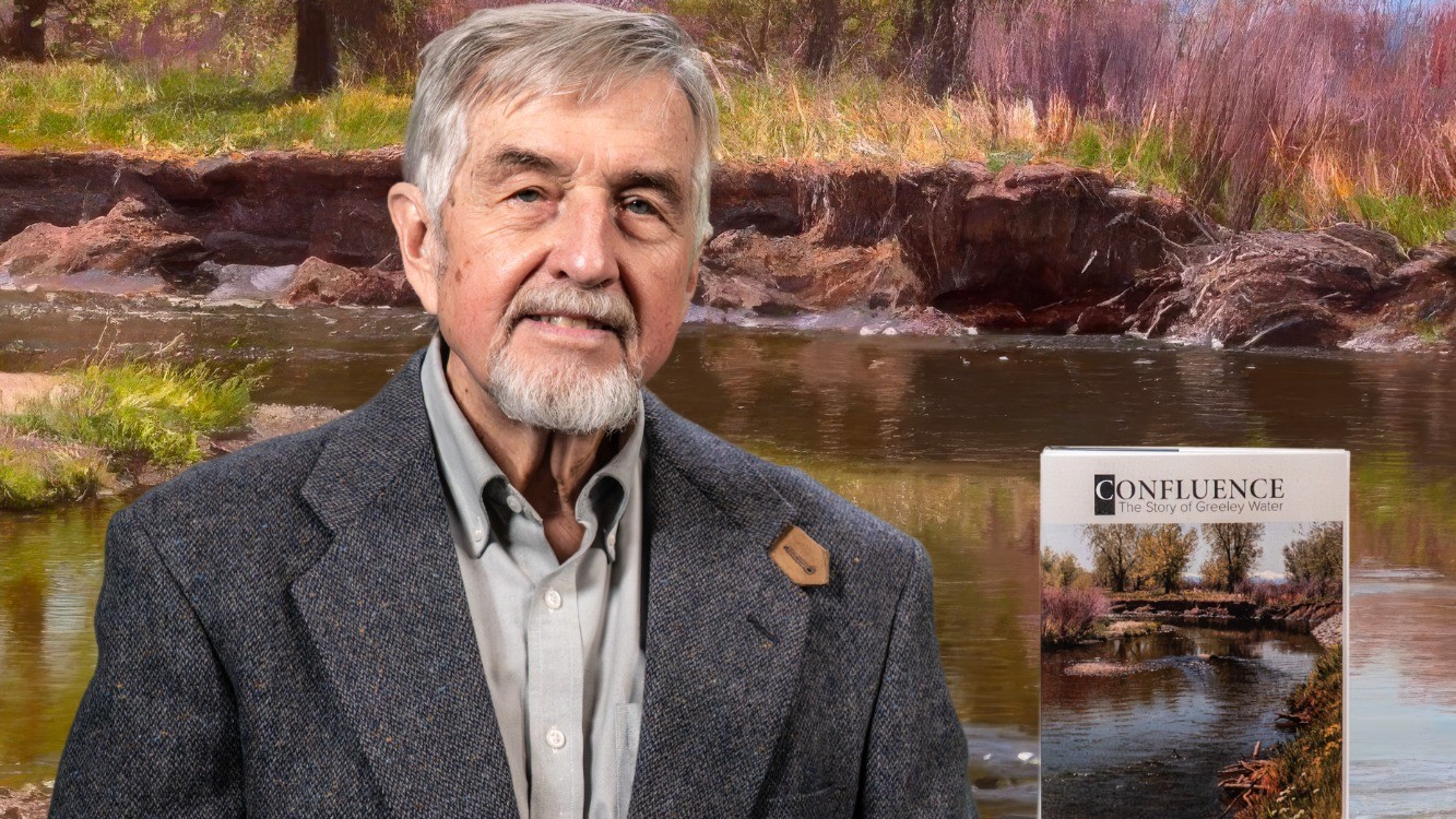 co-author posing with book