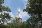 The steeple of the Memorial Church framed by trees on a barckgound of white clouds. The steeple of the Memorial Church framed by trees on a barckgound of white clouds.