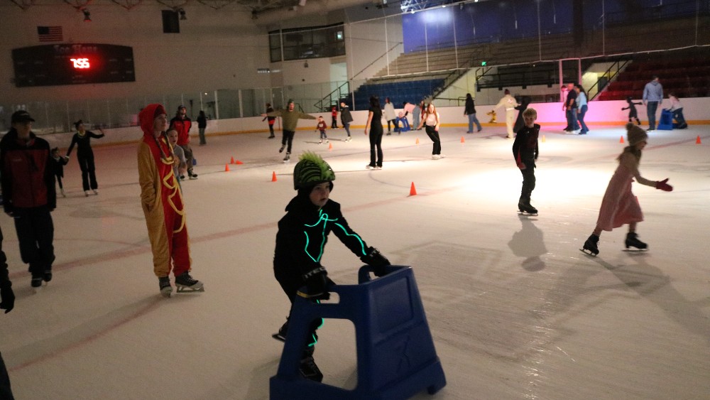 Children and adults skate in Halloween costumes at the Greeley Ice Haus