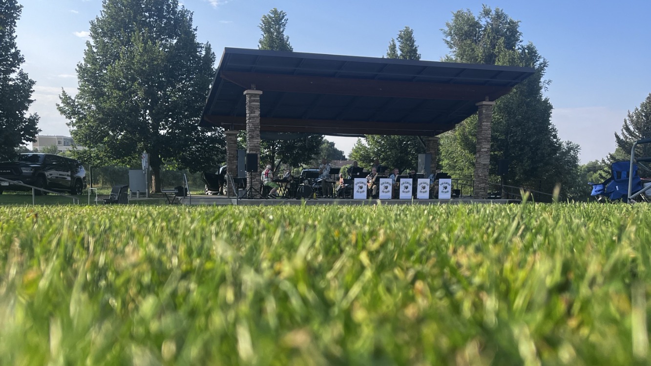 green grass in foreground with Family FunPlex Amphitheater in background